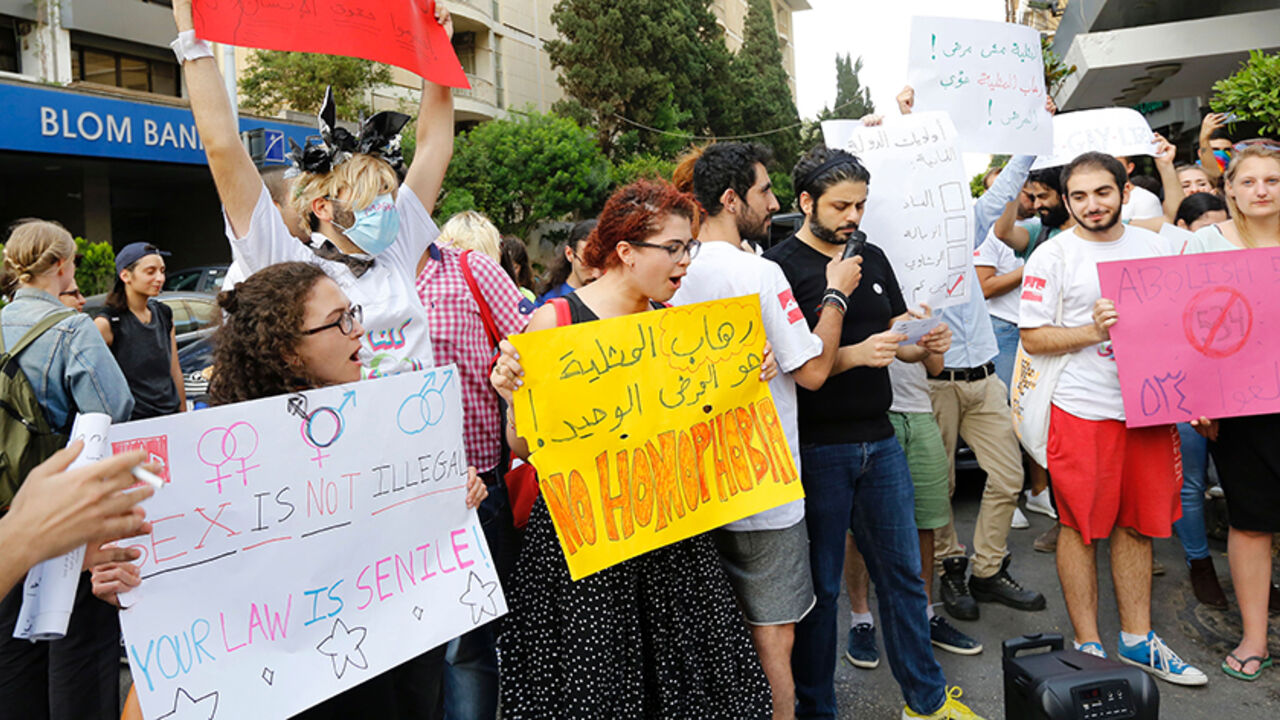 AFP_AQ1AP Activists from of the Lebanese LGBT community take part in a protest outside the Hbeish police station in Beirut on May 15, 2016, demanding the release of four transsexual women and calling for the abolishment of article 534 of the Lebanese Penal code, which prohibits having sexual relations that "contradict the laws of nature". / AFP / ANWAR AMRO (Photo credit should read ANWAR AMRO/AFP/Getty Images)