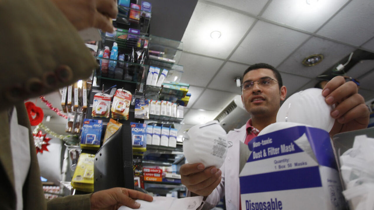 FLU EGYPT/ A doctor buys face masks at a pharmacy in Cairo June 9, 2009. Egypt extended a quarantine of 234 people inside a dormitory at the American University in Cairo on Tuesday, ordering them isolated for a week after five more residents tested positive for the H1N1 flu, the university said. REUTERS/Amr Abdallah Dalsh (EGYPT ENVIRONMENT HEALTH) - RTR24HEL
