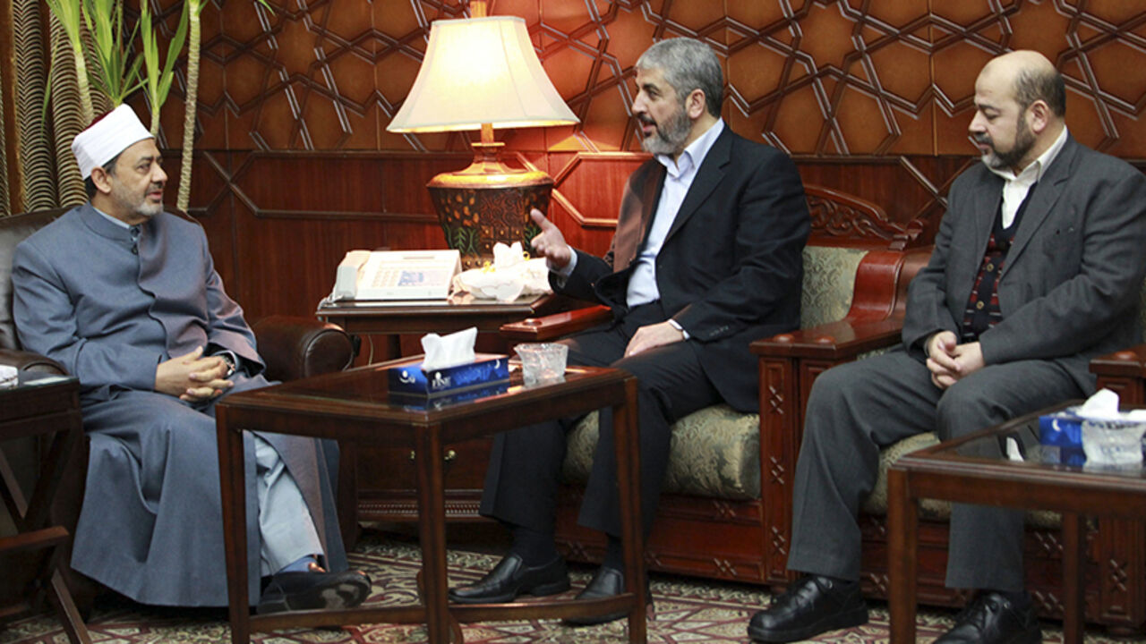 EGYPT/ Senior Hamas leader Khaled Mashal (C), Sheikh Ahmed Mohamed el-Tayeb, Egyptian Imam of al-Azhar Mosque (L) and Mousa Abu Marzouk (R), the deputy-head of Hamas's talk during a Hamas delegation visit to the Imam of al-Azhar mosque in Cairo January 24, 2012. REUTERS/Mohamed Al Hams/Handout (EGYPT - Tags: POLITICS) FOR EDITORIAL USE ONLY. NOT FOR SALE FOR MARKETING OR ADVERTISING CAMPAIGNS. THIS IMAGE HAS BEEN SUPPLIED BY A THIRD PARTY. IT IS DISTRIBUTED, EXACTLY AS RECEIVED BY REUTERS, AS A SERVICE TO CLIEN