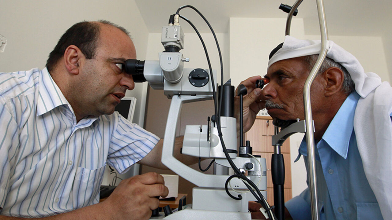 PALESTINIANS-ISRAEL/REFUGEES A Palestinian doctor examines the eyes of a patient at Shams medical centre in Deheishe refugee camp in the West Bank town of Bethlehem May 7, 2012. The new hospital, a stark contrast to Deheishe's general dilapidation, aims to provide services to sufferers of diabetes and hypertension to the handful of refugee camps spread around the Southern West Bank. Three generations of Palestinians displaced by the founding of Israel in 1948 know only life in United Nations refugee camps, going to schools beneath the