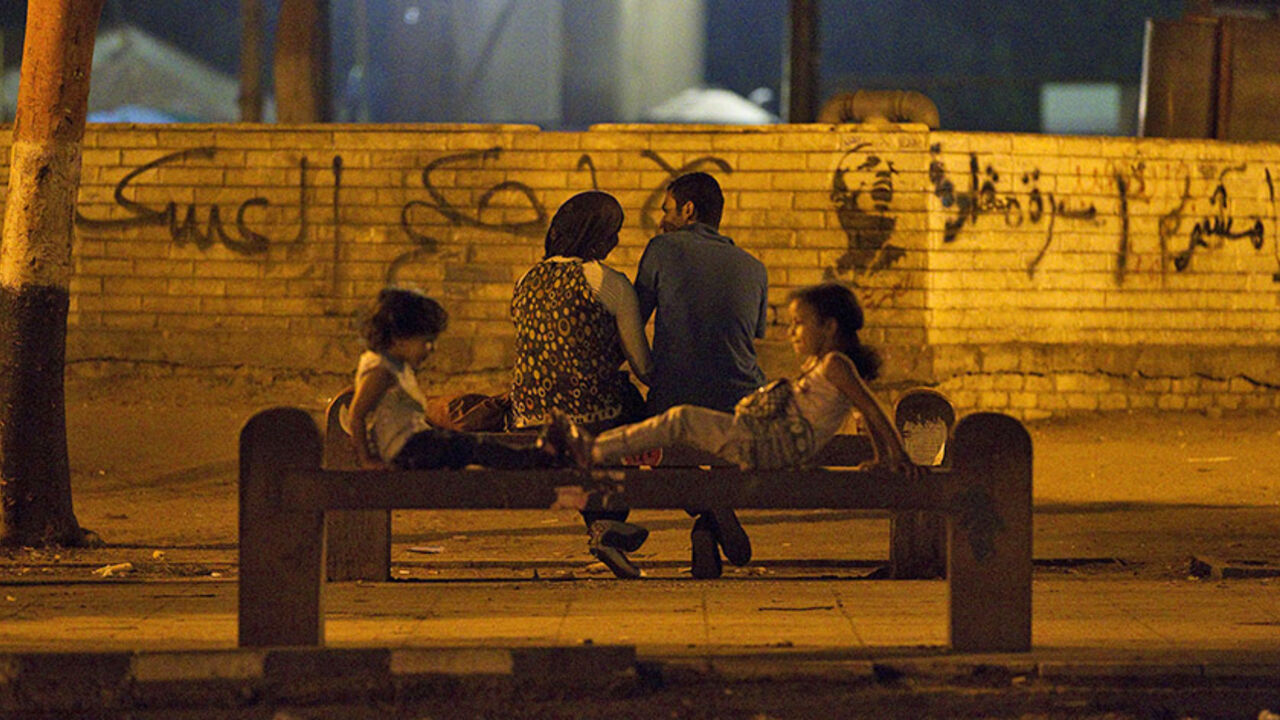 EGYPT-ELECTION/ A couple and children enjoy a calm moment as they sit together at Tahrir Square in Cairo, the focus of the February 2011 Egyptian revolution, shortly before polls closed in the presidential election June 17, 2012. Egypt's Islamists claimed a narrow lead on Monday in vote-counting for the presidential election but the generals who have run the country since the overthrow of Hosni Mubarak issued new rules that made clear real power remains with the army. REUTERS/Steve Crisp (EGYPT - Tags: ELECTIONS POLITICS)