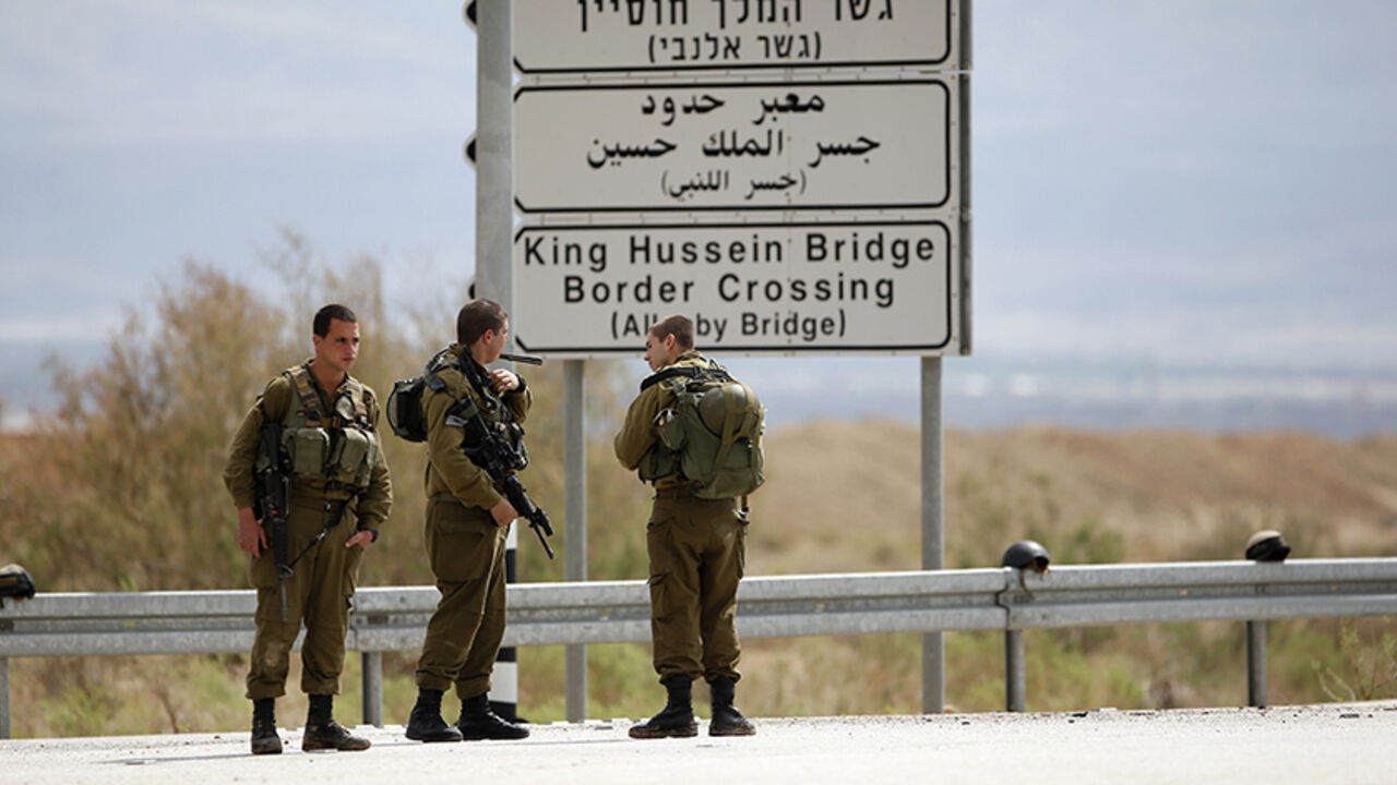 PALESTINIANS-ISRAEL/VIOLENCE Israeli soldiers stand guard near the entrance to Allenby Bridge, a crossing point between Jordan and the occupied West Bank, near the West Bank town of Jericho March 10, 2014. Israeli soldiers shot and killed a Palestinian on Monday at the crossing point, Israeli and Palestinian security officials said. The Israeli military said the man had tried to seize a soldier's gun at the Allenby bridge, which spans the Jordan River, and that troops had then shot him. REUTERS/Ronen Zvulun (WEST BANK - Tags: POLITICS