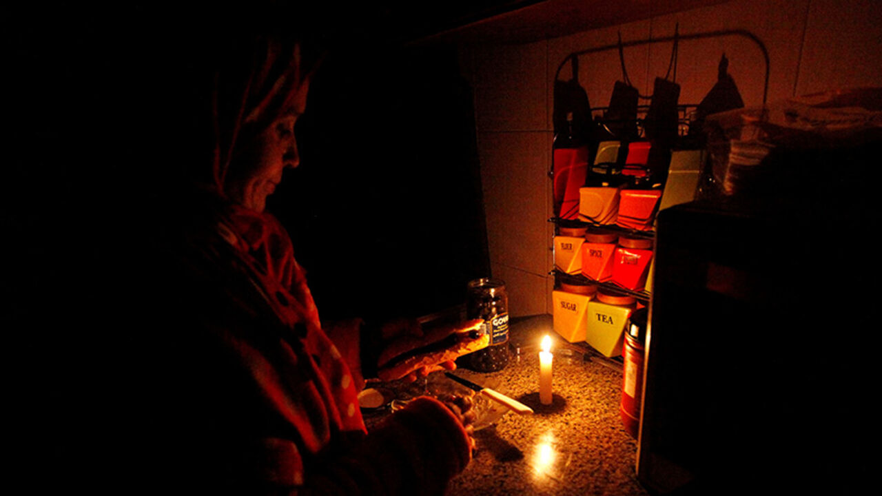 LIBYA-SECURITY/BLACKOUT A woman prepares breakfast in candlelight during a blackout inside a kitchen in her house in Tripoli, Libya, January 15, 2017. REUTERS/Ismail Zitouny - RTSVKY8