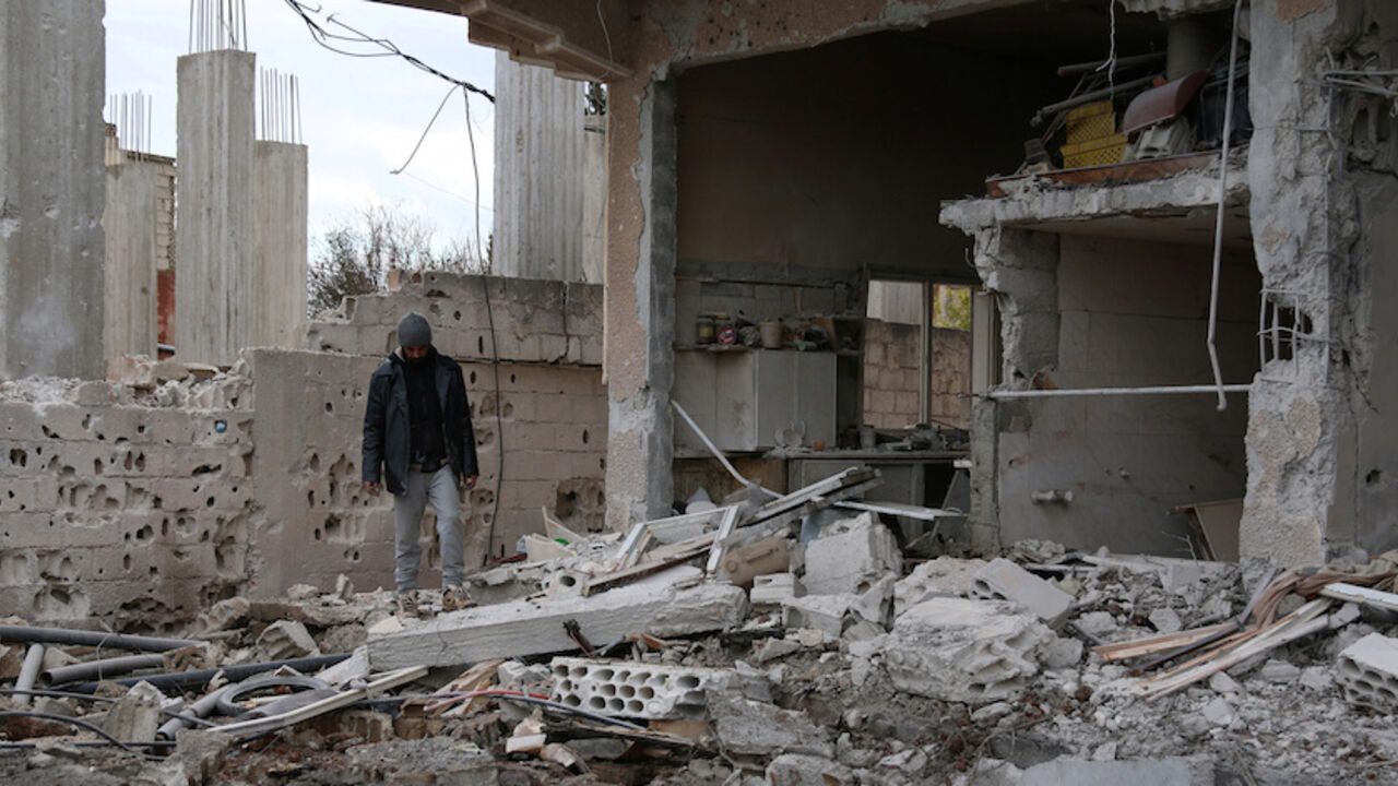 MIDEAST-CRISIS/SYRIA A man inspects a damaged house after an airstrike on al-Yadouda village, in Deraa Governorate, Syria February 15, 2017. REUTERS/Alaa Al-Faqir - RTSYUBP