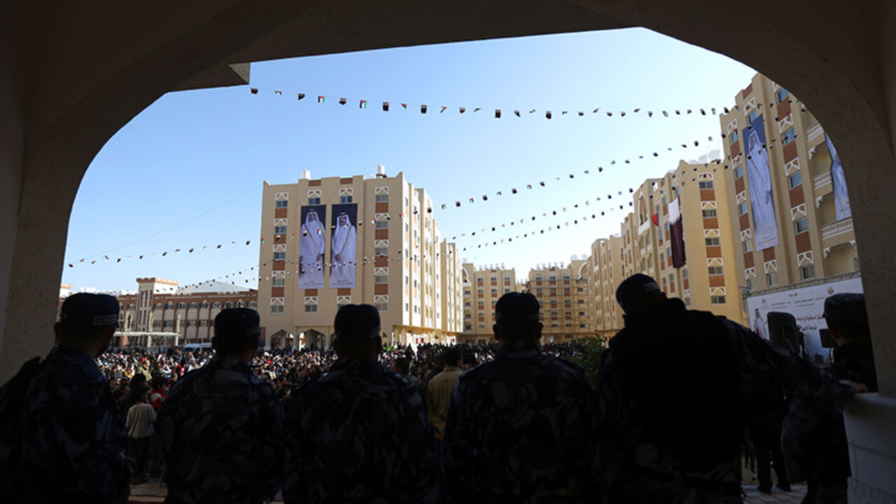 AFP_753GH Palestinian members of the Hamas security forces stand guard during the opening of the Sheikh Hamad residential project in the southern Gaza Strip town of Khan Younis on January 16, 2016.
One thousand units financed by Qatar were attributed to Gazans whose homes were razed during the Israeli offensive on the enclave in 2014 which displaced thousands of people. Qatar pledged 407 million dollars for the reconstruction of Gaza including the construction of apartments, infrastructure and a hospital. / AFP / M