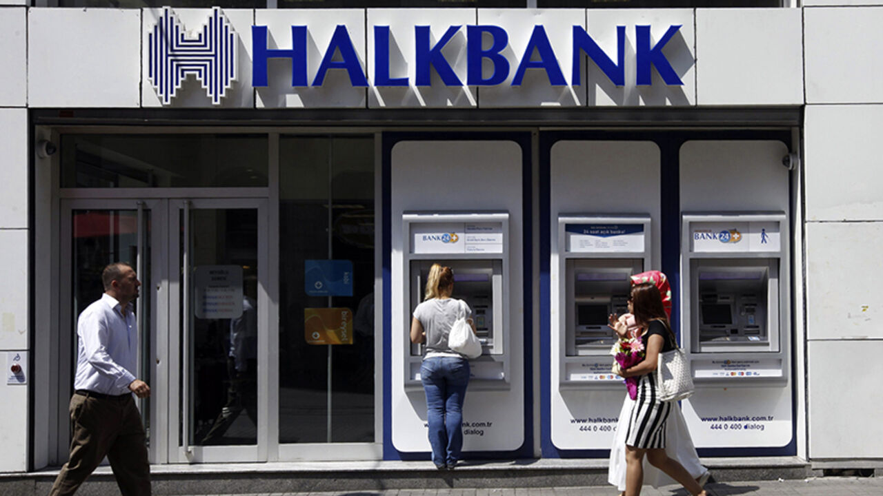 HALKBANK-CACANSKA/ A customer (C) uses an automated teller machine at a branch of Halkbank in Istanbul August 15, 2014. Turkey's state-run lender Halkbank said on Friday it has offer to buy a 76.76 percent stake in Serbian lender Cacanska Banka for an undisclosed sum. Halkbank offered no further details on the potential acquisition in a statement to the Istanbul stock exchange. REUTERS/Osman Orsal (TURKEY - Tags: BUSINESS) - RTR42JV5