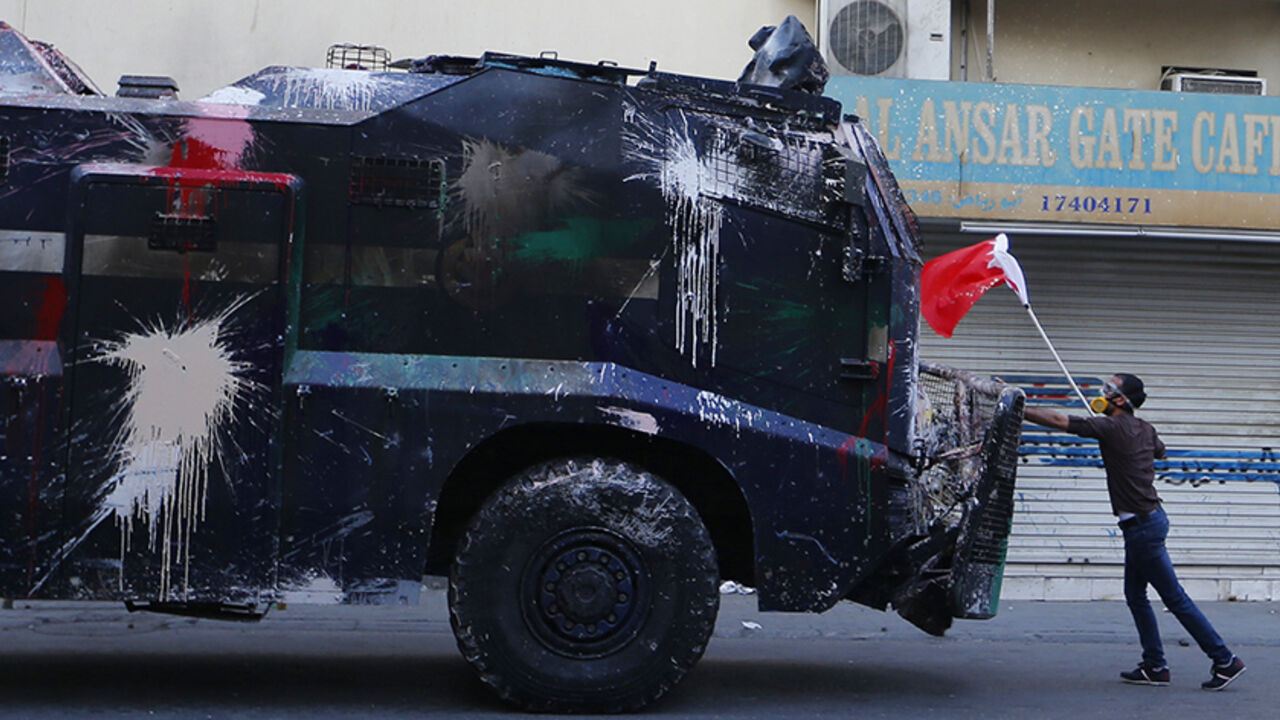 BAHRAIN-COURTS/ A protester, holding a Bahraini flag, confronts a riot police armoured personnel carrier in an attempt to stop it from entering the village of Bilad Al Qadeem south of Manama, January 6, 2015.
Bahraini police fired rubber bullets and tear gas to scatter protesters who gathered outside the home of Sheikh Ali Salman, a Shi'ite Muslim opposition leader on Monday, witnesses said, after he was remanded in custody for a further 15 days. Around 100 protesters angry at the decision had assembled outside his house