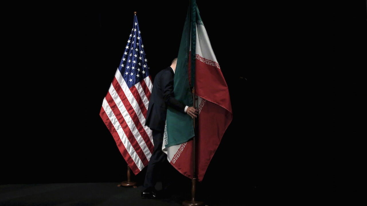 STORY-YEAR ENDER/2015 A staff member removes the Iranian flag from the stage during the Iran nuclear talks in Vienna, Austria July 14, 2015. Carlos Barria: For more than a decade the United States and other world powers have participated in talks to reach an agreement on Iranís nuclear program. They and Iran have spent thousands of hours around a table seeking a solution to what the West sees as a threat to global stability if Iran gains the capability to make a nuclear bomb. The last chapter was in Vienna, where I travelled wit