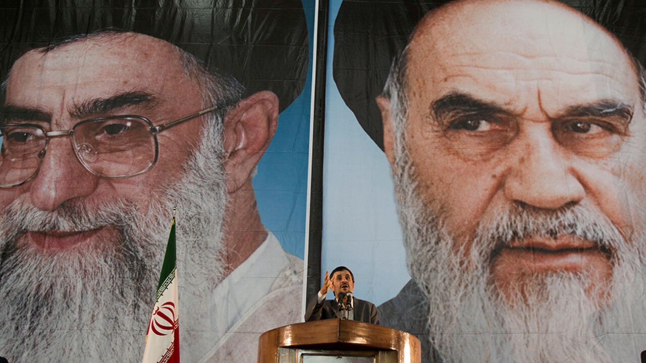 IRAN-POLITICS/AHMADINEJAD Iranian President Mahmoud Ahmadinejad stands under pictures of Iran's Supreme Leader Ayatollah Ali Khamenei (L) and Iran's late leader Ayatollah Ruhollah Khomeini while speaking during a ceremony to mark Khomeini's death anniversary at his tomb at Tehran's Behesht-Zahra cemetery June 3, 2011. REUTERS/Morteza Nikoubazl/File Photo - RTX2DZ1L
