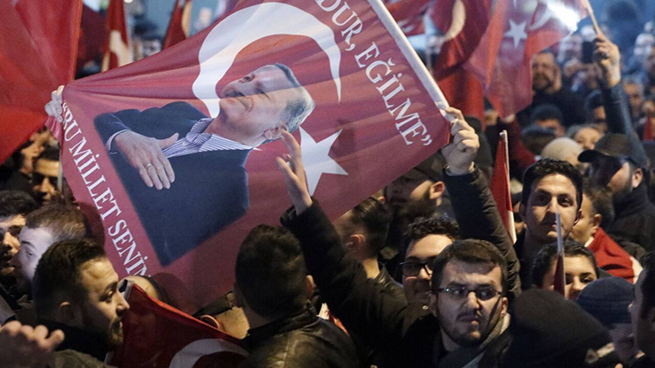 TURKEY-REFERENDUM/NETHERLANDS Demonstrators with banners of Turkish President Recep Tayyip Erdogan gather outsidethe Turkish consulate to welcome the Turkish Family Minister Fatma Betul Sayan Kaya, who decided to travel to Rotterdam by land after Turkish Foreign Minister Mevlut Cavusoglu's flight was barred from landing by the Dutch government, in Rotterdam, Netherlands March 11, 2017. REUTERS/Yves Herman - RTX30MBC