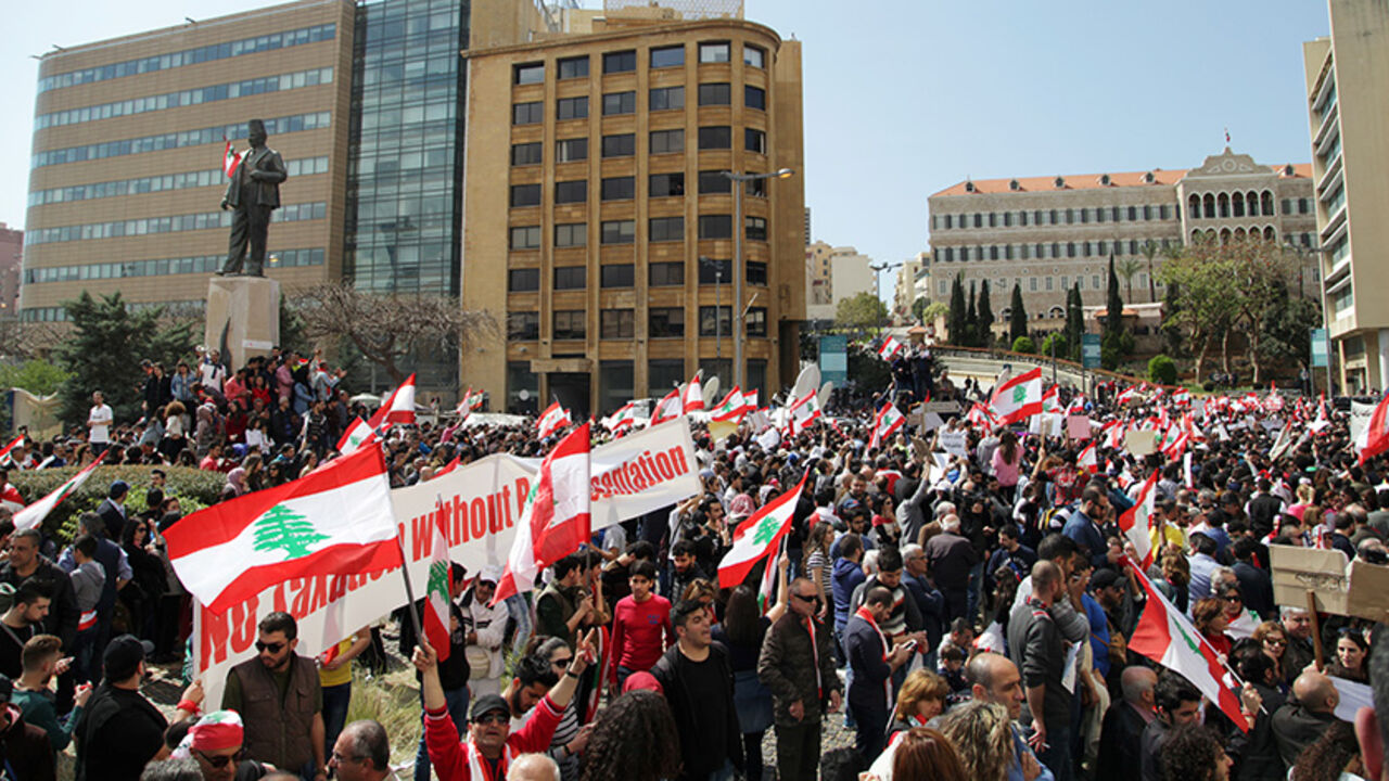 LEBANON-POLITICS/PROTEST Protesters wave Lebanese national flags during a demonstration against proposed tax increase, in front of the government palace in Beirut, Lebanon March 19, 2017. REUTERS/Alia Haju - RTX31PEJ