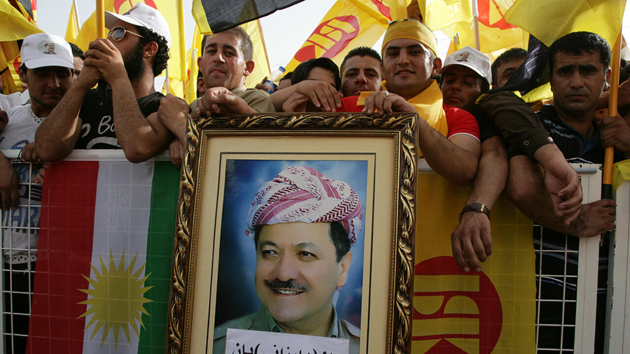 Nic6219492 Massoud Barzani (portrait), the president of the Kurdish regional government in northern Iraq and leader of the Kurdistan Democratic Party, wave the party's flag (R) and the Kurdish flag (L) as he delivers a speech in the northern Iraqi Kurdish city of Arbil on May 26, 2013. AFP PHOTO / SAFIN HAMED (Photo credit should read SAFIN HAMED/AFP/Getty Images)