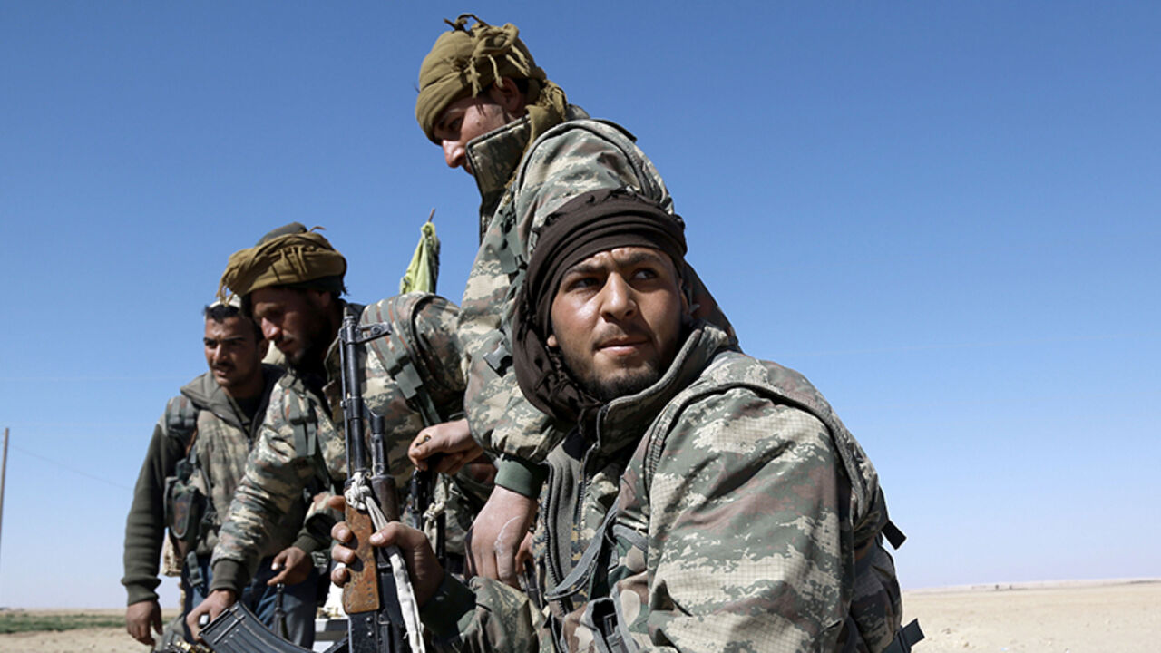 TOPSHOT - US-backed Syrian Democratic Forces (SDF), made up of an alliance of Arab and Kurdish fighters, advance in the village of Sabah al-Khayr on the northern outskirts of Deir Ezzor as they drive to encircle the Islamic State (IS) group bastion of Raqa on February 21, 2017.
The SDF made a major incursion into the oil-rich province of Deir Ezzor as part of their push for Raqa, field commander Dejwar Khabat said. 



 / AFP / DELIL SOULEIMAN        (Photo credit should read DELIL SOULEIMAN/AFP/Getty Image