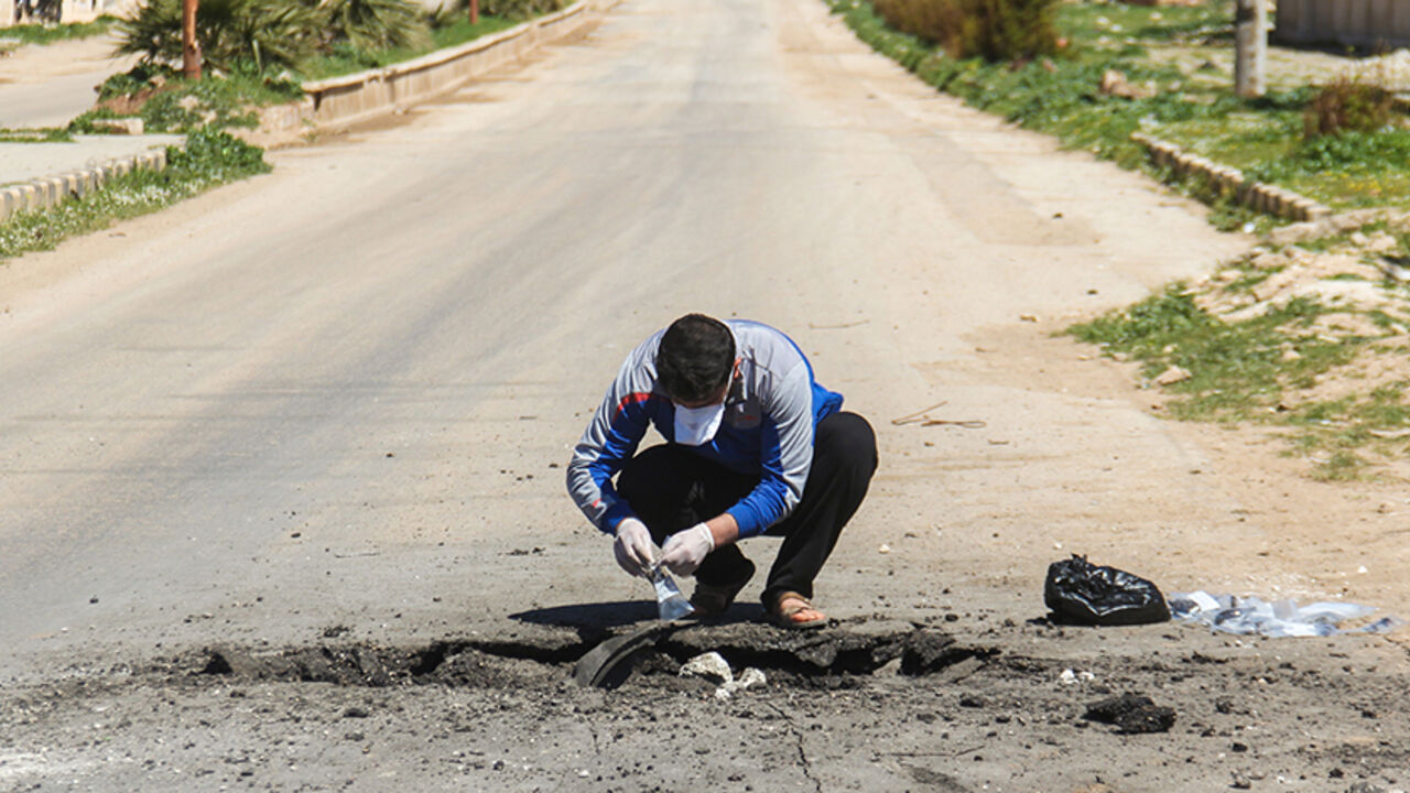 AFP_NA4N1 A Syrian man collects samples from the site of a suspected toxic gas attack in Khan Sheikhun, in Syrias northwestern Idlib province, on April 5, 2017.
International outrage is mounting over a suspected chemical attack that killed scores of civilians in Khan Sheikhun on April 4, 2017. / AFP PHOTO / Omar haj kadour (Photo credit should read OMAR HAJ KADOUR/AFP/Getty Images)