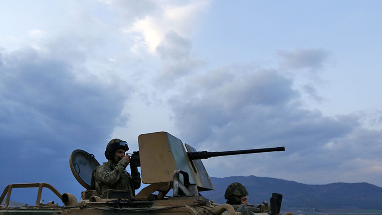 MIDEAST-CRISIS/SYRIA-TURKEY-BORDER A Turkish soldier on an armoured military vehicle surveys the border line between Turkey and Syria, near the southeastern city of Kilis, Turkey, March 2, 2017. REUTERS/Murad Sezer - RTS115IB