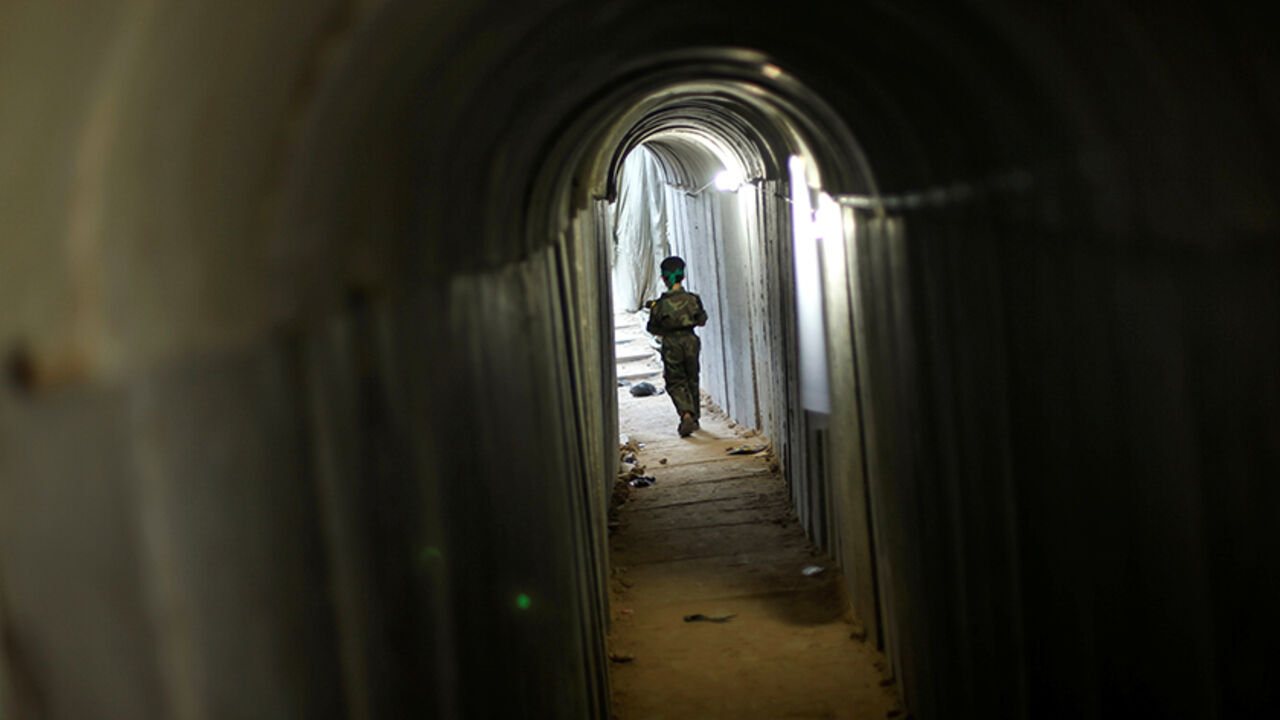 PALESTINIANS-MILITARY/ A Palestinian boy walks in a tunnel as he takes part in a military exercise graduation ceremony at a summer camp organised by Hamas's armed wing, east of Gaza City July 22, 2016. REUTERS/Mohammed Salem - RTSJ8Z8