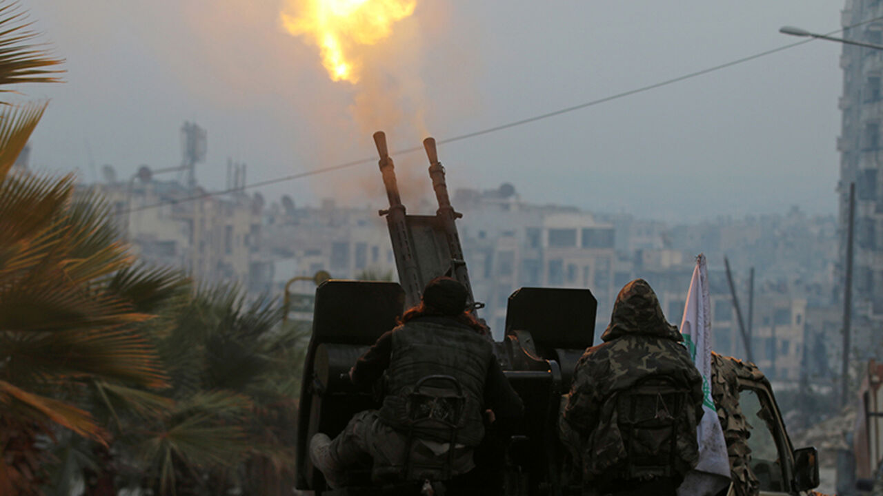 MIDEAST-CRISIS/SYRIA-ALEPPO Free Syrian Army fighters fire an anti-aircraft weapon in a rebel-held area of Aleppo, Syria December 12, 2016. REUTERS/Abdalrhman Ismail - RTX2UP7M