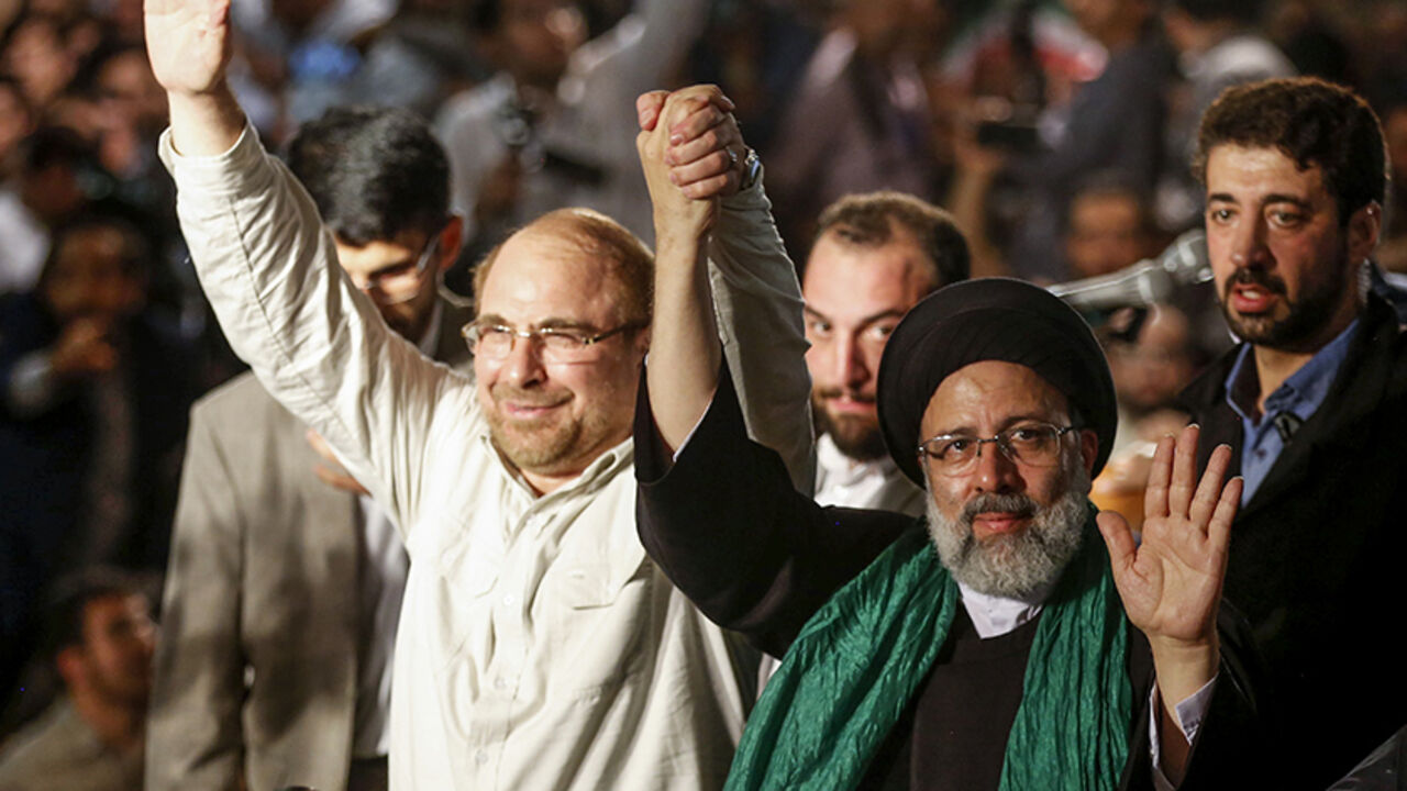 AFP_OG5XQ Iranian presidential candidate Ebrahim Raisi (R-2) holds hands with former presidential candidate and mayor of Tehran, Mohammad Bagher Ghalibaf (L), as he greets his supporters during a campaign rally at Imam Khomeini Mosque in the capital Tehran on May 16, 2017.
Iran's presidential election on May 19 is effectively a choice between moderate incumbent Hassan Rouhani and hardline jurist Raisi, with major implications for everything from civil rights to relations with Washington. / AFP PHOTO / ATTA KENARE
