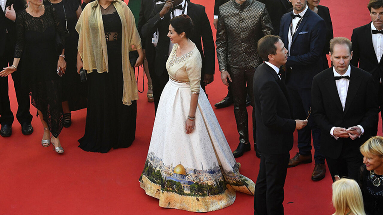 AFP_OI4CL Israeli Culture Minister Miri Regev wearing a dress featuring the old city of Jerusalem arrives on May 17, 2017 for the screening of the film 'Ismael's Ghosts' (Les Fantomes d'Ismael) during the opening ceremony of the 70th edition of the Cannes Film Festival in Cannes, southern France. / AFP PHOTO / Antonin THUILLIER (Photo credit should read ANTONIN THUILLIER/AFP/Getty Images)