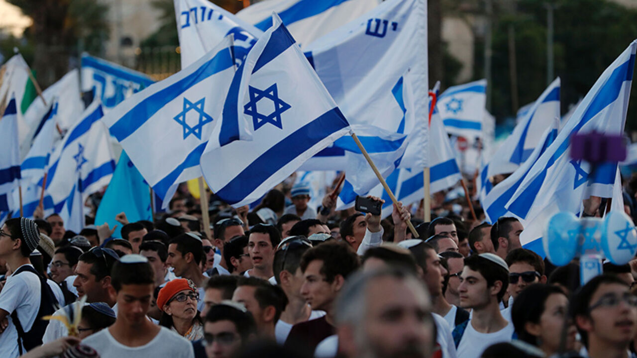 AFP_OV20B Far right Israeli supporters wave the Israeli flag as they demonstrate on May 24, 2017 in front of Damascus Gate in Jerusalem's Old City to commemorate Jerusalem Day, marking the establishment of Israeli control over the Old City following its capture in the Six-Day War of 1967. / AFP PHOTO / Thomas COEX (Photo credit should read THOMAS COEX/AFP/Getty Images)