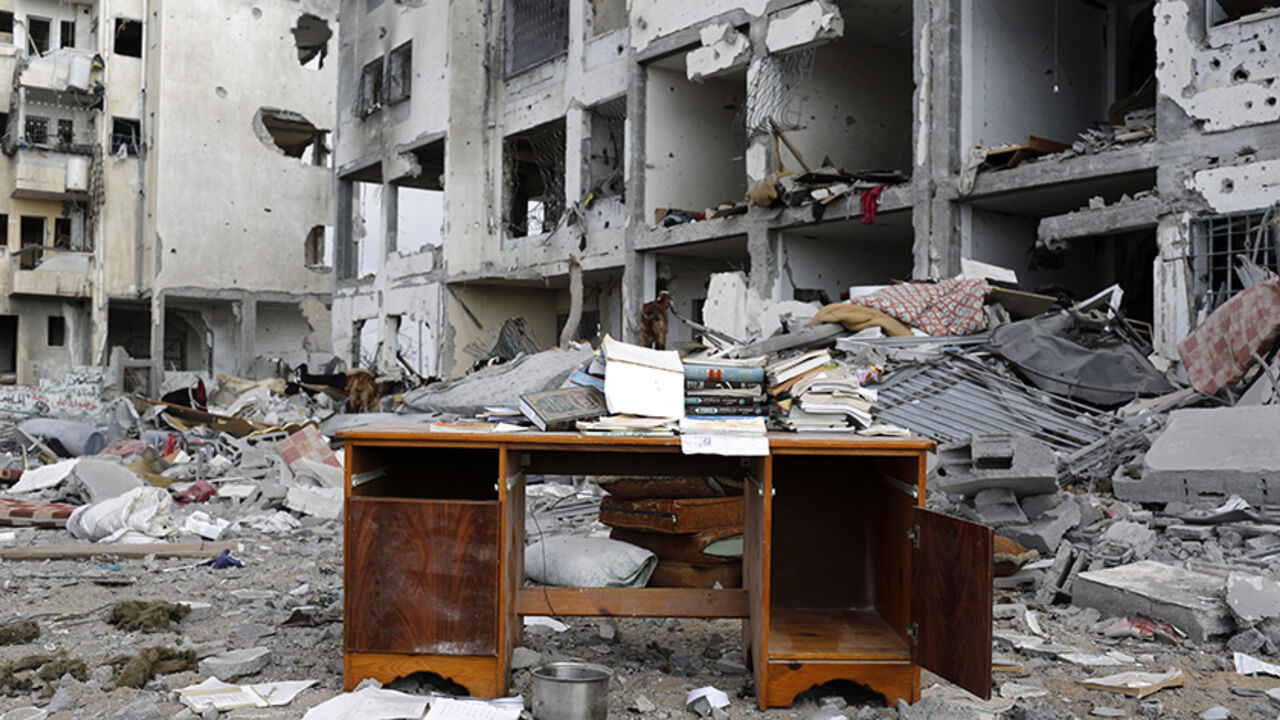 MIDEAST-GAZA/ A desk sits amid the debris of buildings destroyed by what police said were Israeli airstrikes and shelling in the town of Beit Lahiya in the northern Gaza Strip August 3, 2014. Israel's month-long war against Hamas, with Israel carrying out air strikes, artillery bombardments and ground operations in response to constant militant rocket fire and attacks via tunnels, left more than 2,000 Palestinians dead, most of them civilians, as well as 64 Israeli soldiers and three civilians. It was the deadliest war i