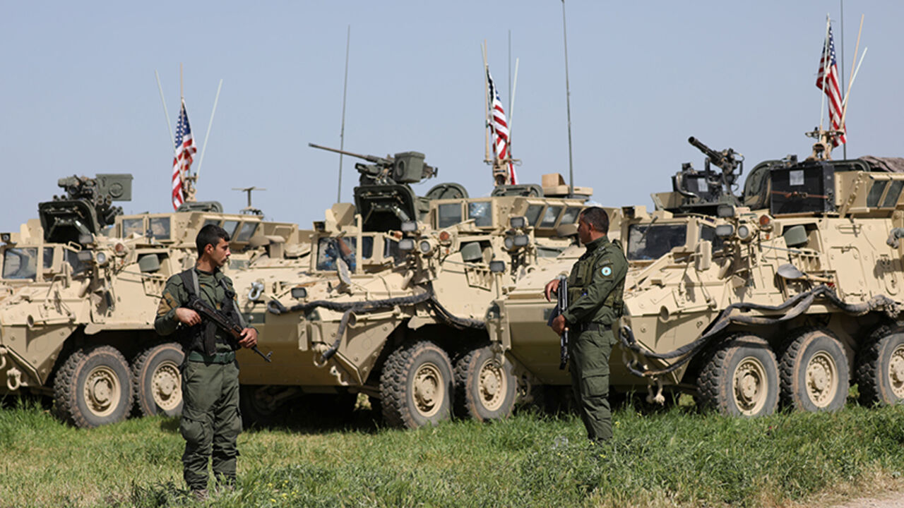 MIDEAST-CRISIS/SYRIA-KURDS Kurdish fighters from the People's Protection Units (YPG) stand near U.S military vehicles in the town of Darbasiya next to the Turkish border, Syria April 29, 2017. Picture taken April 29, 2017. REUTERS/Rodi Said - RTS14IHP