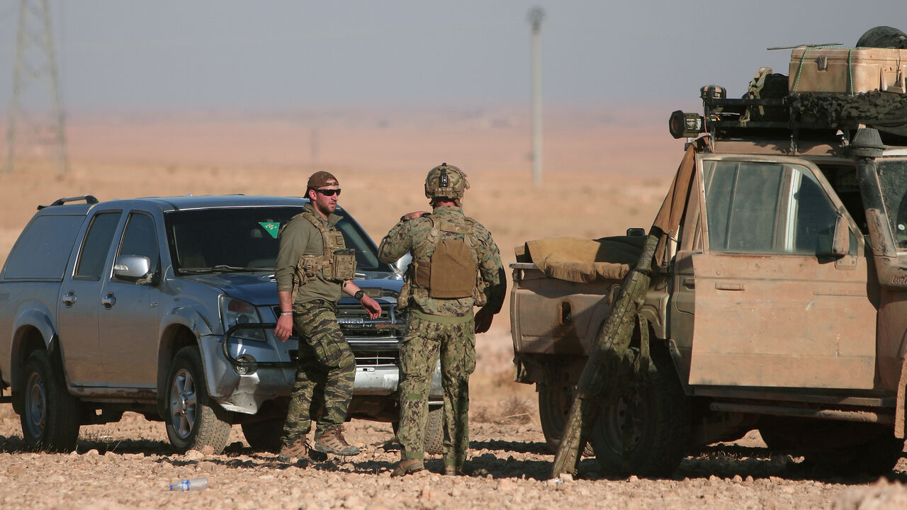 MIDEAST-CRISIS/SYRIA-RAQQA U.S. fighters stand near military vehicles, north of Raqqa city, Syria November 6, 2016. REUTERS/Rodi Said - RTX2S5R9