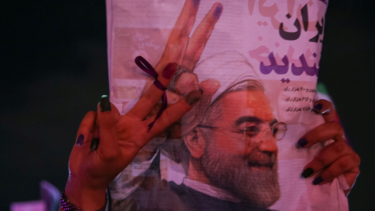 IRAN-ELECTION/ A supporter of Iranian president Hassan Rouhani holds his poster as she celebrates his victory in the presidential election, in Tehran, Iran, May 20, 2017. TIMA via REUTERS ATTENTION EDITORS - THIS IMAGE WAS PROVIDED BY A THIRD PARTY. FOR EDITORIAL USE ONLY. TPX IMAGES OF THE DAY - RTX36RDP