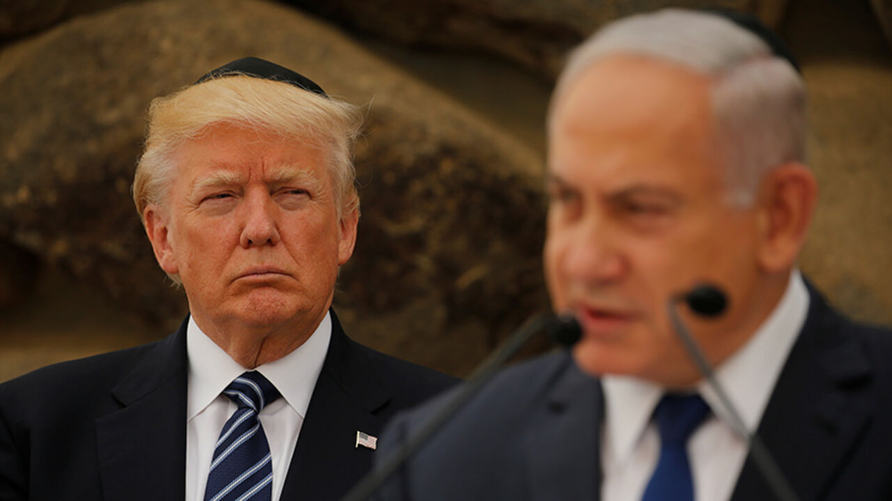 USA-TRUMP/ISRAEL Israeli Prime Minister Benjamin Netanyahu talks on a podium as U.S. President Donald Trump listens during a ceremony commemorating the six million Jews killed by the Nazis in the Holocaust, in the Hall of Remembrance at Yad Vashem Holocaust memorial in Jerusalem May 23, 2017. REUTERS/Jonathan Ernst - RTX376QY