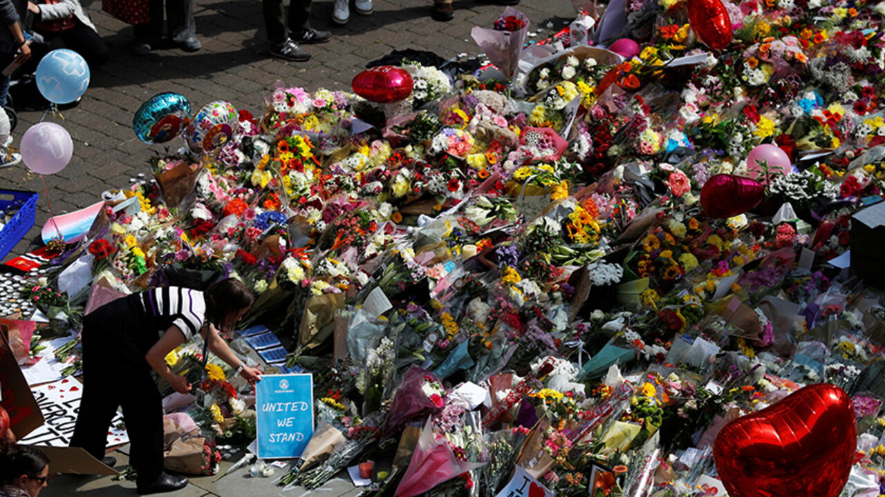 BRITAIN-SECURITY/MANCHESTER City council employees move flowers from the townhall in Albert Square to St Ann's Square in Manchester, Britain, May 24, 2017. REUTERS/Peter Nicholls - RTX37ERD