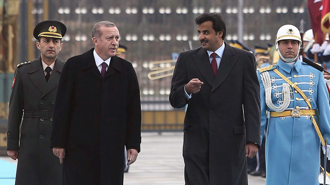 Par8058336 Qatari Crown Prince Sheikh Tamim bin Hamad bin Khalifa al-Thani (2ndR) and Turkish President Recep Tayyip Erdogan (2ndL), walk past a guard of honor during an official welcoming ceremony prior to their meeting at the presidential palace in Ankara, Turkey, on December 19, 2014. AFP PHOTO / ADEM ALTAN (Photo credit should read ADEM ALTAN/AFP/Getty Images)