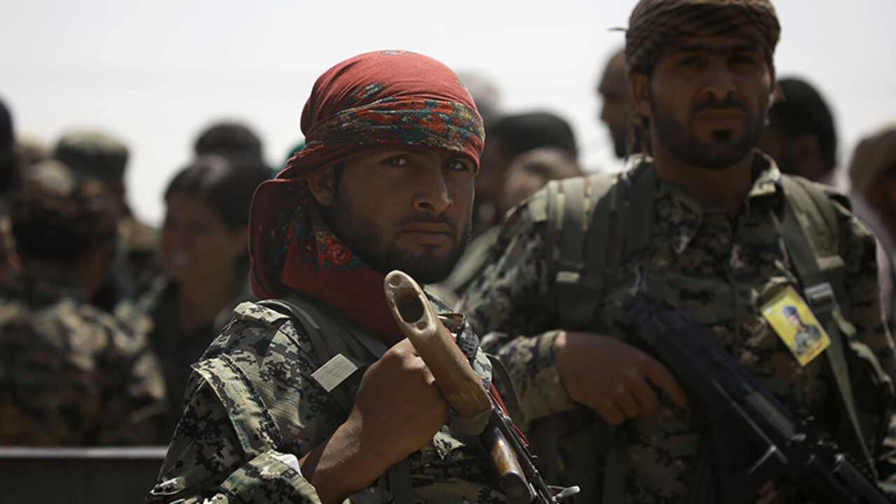 AFP_PA9BN Members of the US-backed Syrian Democratic Forces (SDF) stand in the village of Hazima on the northern outskirts of the Islamic States (IS) group's Syrian bastion of Raqa on June 6, 2017.
SDF broke into Raqa less than an hour after declaring a new phase in their fight for the city. / AFP PHOTO / DELIL SOULEIMAN (Photo credit should read DELIL SOULEIMAN/AFP/Getty Images)