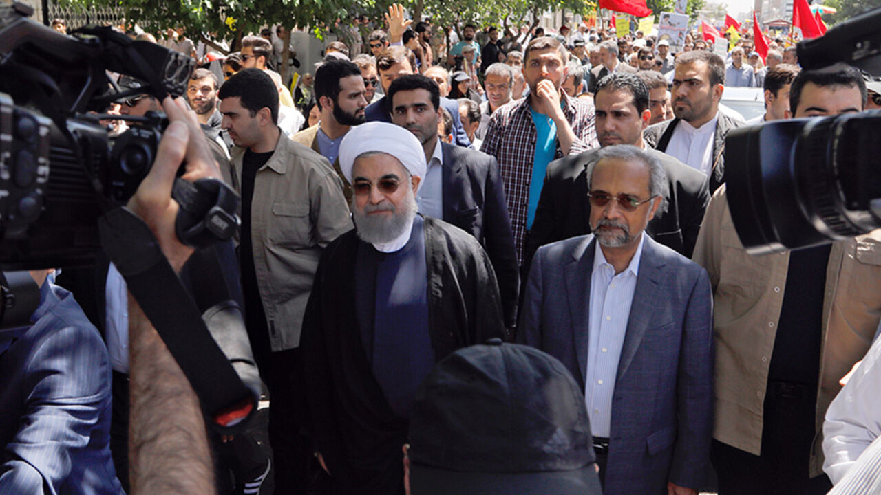 AFP_PU7NY Iranian president Hassan Rouhani takes part in a rally marking al-Quds (Jerusalem) Day in Tehran on June 23, 2017.
Chants against the Saudi royal family and the Islamic State group mingled with the traditional cries of "Death to Israel" and "Death to America" at Jerusalem Day rallies across Iran today.
/ AFP PHOTO / Stringer (Photo credit should read STRINGER/AFP/Getty Images)