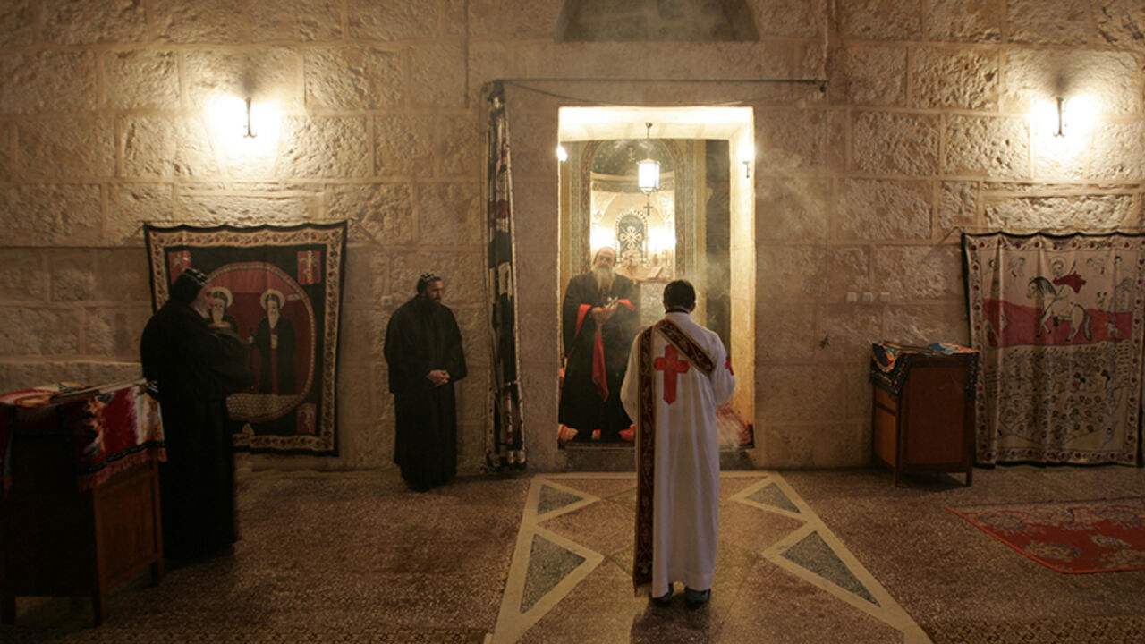RELIGION-TURKEY/CHRISTIANS Syriac Christian monks attend a service at the ancient monastery of Mor Gabriel, 15 km (9 miles) away from the town of Midyat, in Mardin province of southeast Turkey January 13, 2009. Tucked amid rugged hills where mosques and minarets are silhouetted in the distance, the fifth century Mor Gabriel monastery stands out as a relic of another era when hundreds of thousands of Syriac Christians lived and worshipped in Turkey. But a land dispute between Mor Gabriel and neighbouring villages is threatening the mo
