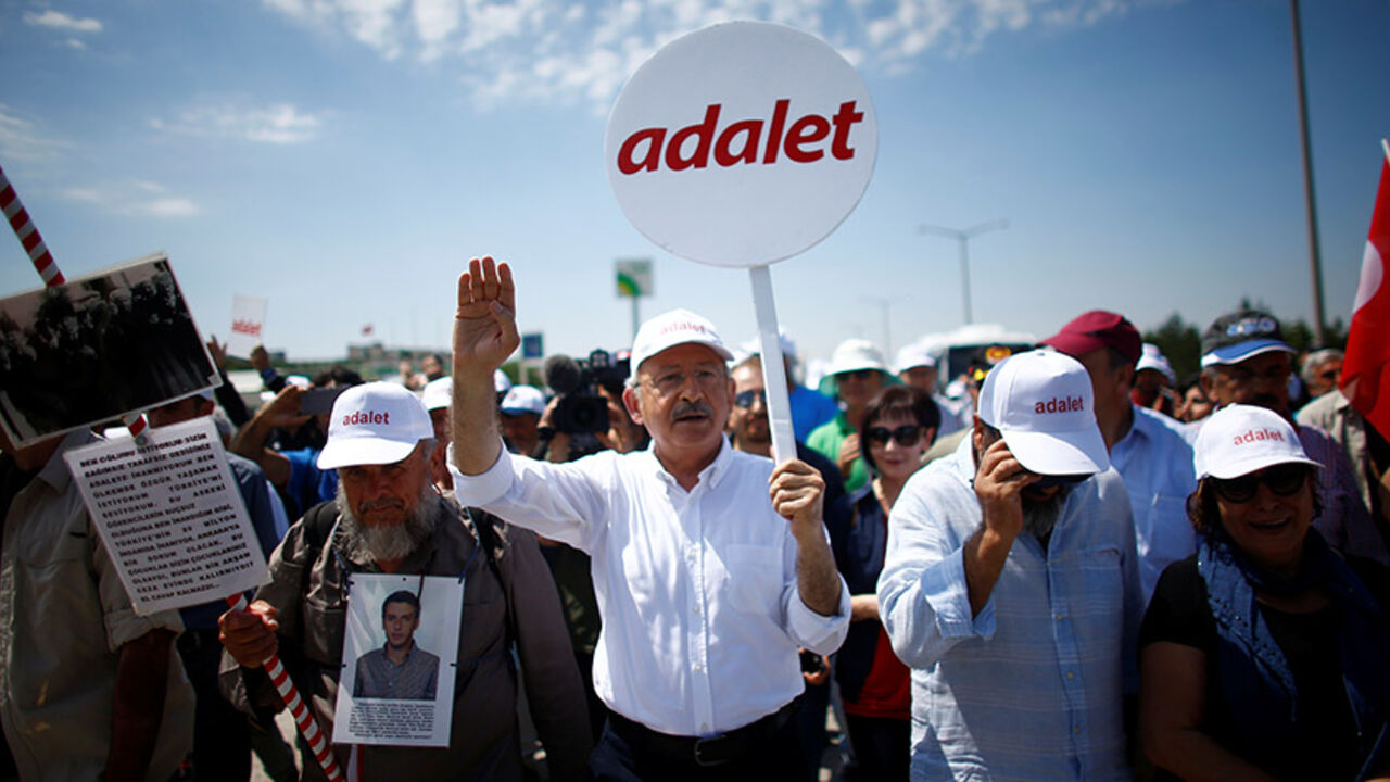 TURKEY-SECURITY-LAWMAKER Turkey's main opposition Republican People's Party (CHP) leader Kemal Kilicdaroglu walks during the third day of a protest, dubbed "justice march", against the detention of his party's lawmaker Enis Berberoglu, on the outskirts of Ankara, Turkey June 17, 2017. Placard reads, "Justice". REUTERS/Osman Orsal - RTS17GE4