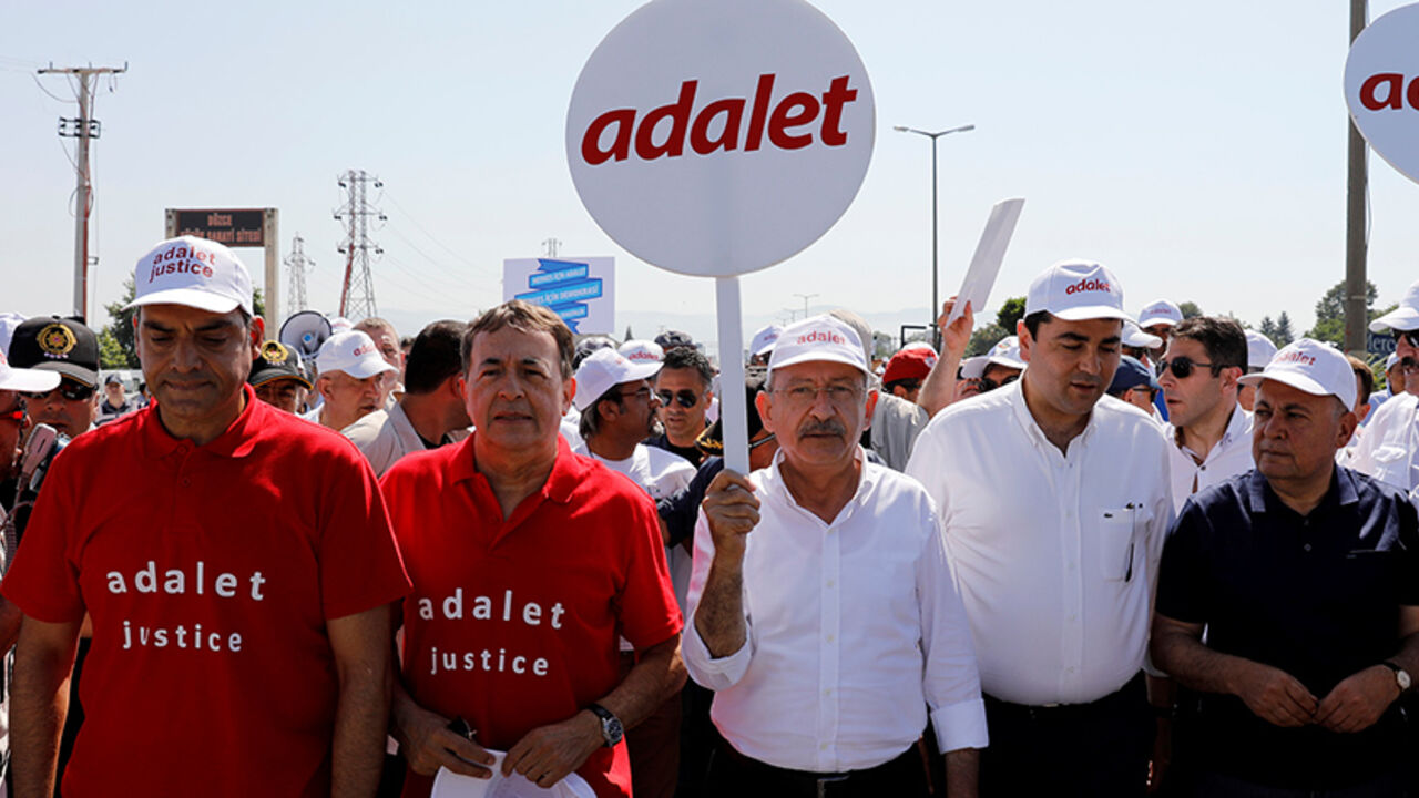 TURKEY-SECURITY/LAWMAKER Turkey's main opposition Republican People's Party (CHP) leader Kemal Kilicdaroglu (C) and Secretay General of the Socialist International Luis Ayala (2nd L) walk flanked by supporters during the 14th day of a protest dubbed "justice march" against the detention of CHP's lawmaker Enis Berberoglu, in Duzce, Turkey June 28, 2017. The placard reads "Justice". REUTERS/Umit Bektas - RTS18YW1