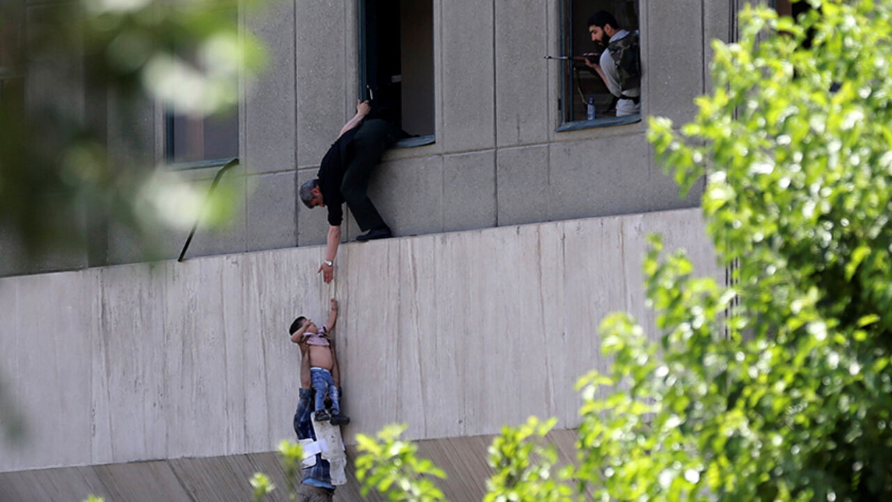 IRAN-SECURITY/ A boy is evacuated during an attack on the Iranian parliament in central Tehran, Iran, June 7, 2017. Omid Vahabzadeh/TIMA via REUTERS ATTENTION EDITORS - THIS IMAGE WAS PROVIDED BY A THIRD PARTY. FOR EDITORIAL USE ONLY. THIS PICTURE WAS PROCESSED BY REUTERS TO ENHANCE QUALITY. AN UNPROCESSED VERSION HAS BEEN PROVIDED SEPARATELY. TPX IMAGES OF THE DAY - RTX39ENI