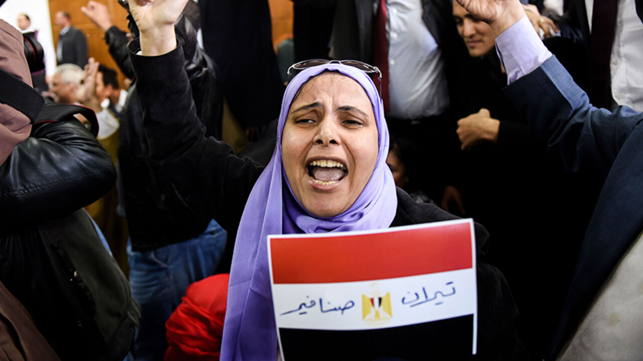 AFP_K10FO An Egyptian woman celebrates with a national flag defaced with the words "Tiran" and "Sanafir" after the High Administrative Court upheld on January 16, 2017 a ruling voiding a government agreement to hand over the two Red Sea islands of Tiran and Sanafir to Saudi Arabia in a deal that had sparked protests in Egypt. / AFP / MOHAMED EL-SHAHED (Photo credit should read MOHAMED EL-SHAHED/AFP/Getty Images)