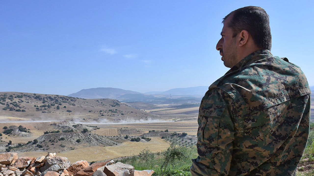 AFP_PF0EJ A fighter from the Kurdish People's Protection Units (YPG) monitors in the area of Afrin, along Syria's northern border with Turkey, on June 9, 2017. / AFP PHOTO / George OURFALIAN (Photo credit should read GEORGE OURFALIAN/AFP/Getty Images)
