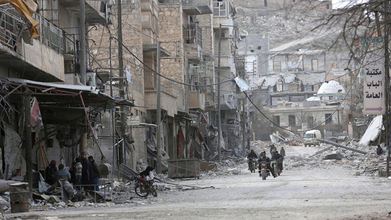 MIDEAST-CRISIS/SYRIA People ride motorcycles amidst the rubble of damaged buildings in the northern Syrian town of al-Bab, Syria, February 28, 2017. REUTERS/Khalil Ashawi - RTS10UG7
