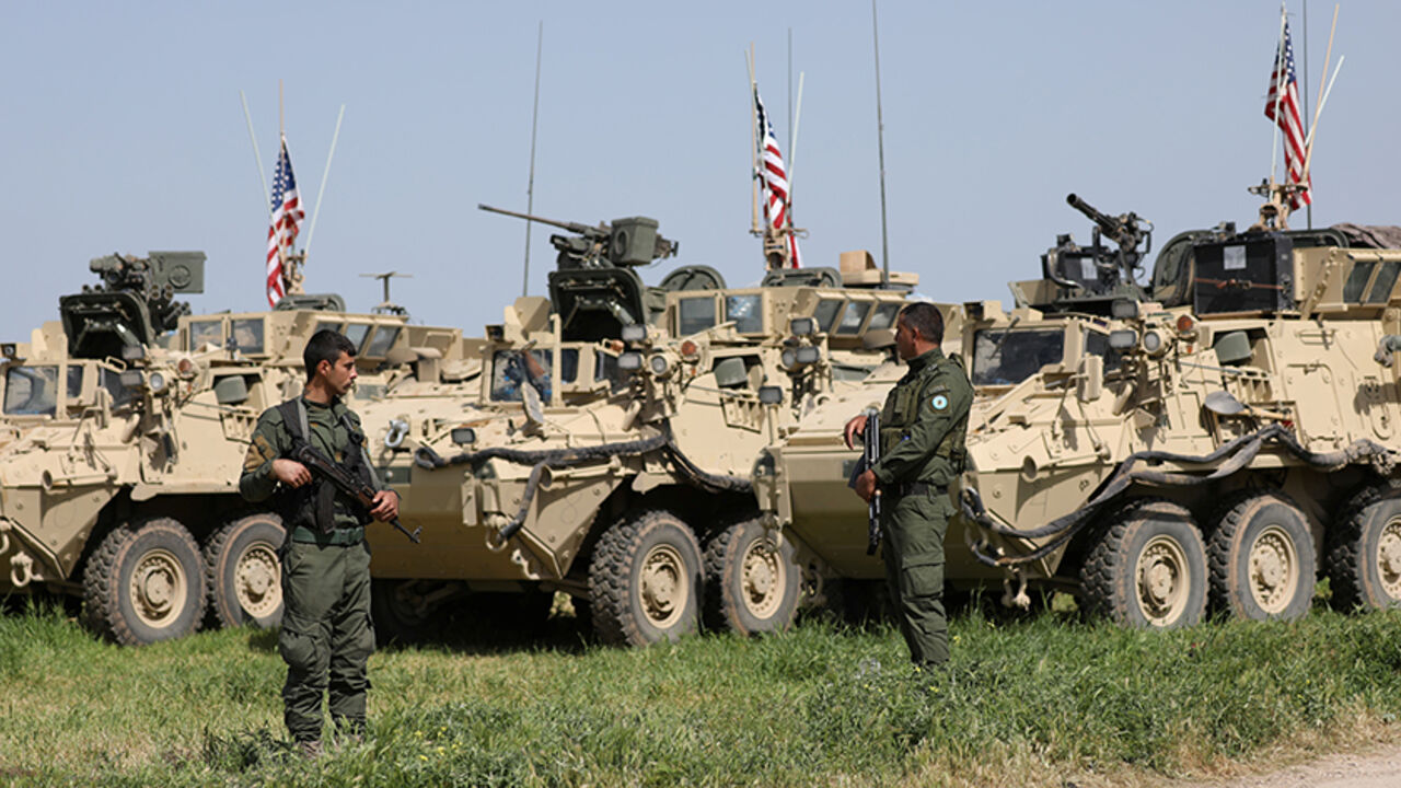 MIDEAST-CRISIS/SYRIA-KURDS Kurdish fighters from the People's Protection Units (YPG) stand near U.S military vehicles in the town of Darbasiya next to the Turkish border, Syria April 29, 2017. Picture taken April 29, 2017. REUTERS/Rodi Said - RTS14IHP