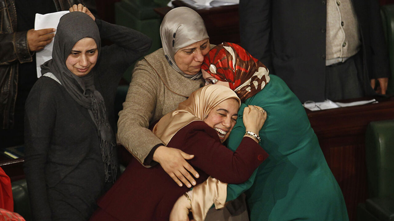 TUNISIA-POLITICS/ Members of the Tunisian parliament celebrate after approving the country's new constitution in the assembly building in Tunis January 26, 2014. Tunisia's national assembly approved the country's new constitution on Sunday in one of the final steps to full democracy three years after protests erupted into an uprising that toppled autocrat Zine el-Abidine Ben Ali. REUTERS/Zoubeir Souissi (TUNISIA - Tags: POLITICS TPX IMAGES OF THE DAY) - RTX17W7W