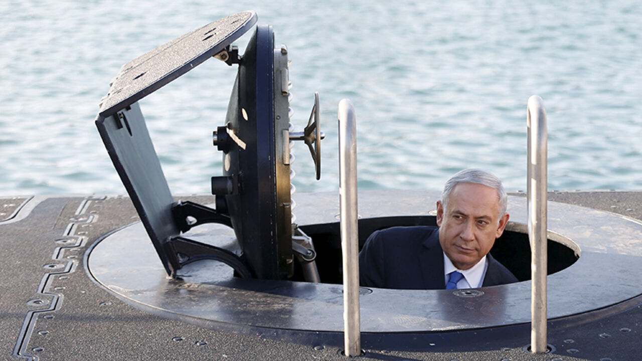 ISRAEL-ARMS/ Israeli Prime Minister Benjamin Netanyahu climbs out after a visit inside the Rahav, the fifth submarine in the fleet, after it arrived in Haifa port January 12, 2016. The Dolphin-class submarines, widely believed to be capable of firing nuclear missiles, were manufactured in Germany and sold to Israel at deep discounts as part of Berlin's commitment to shoring up the security of the country set in part as a haven for Jews who survived the Holocaust.REUTERS/Baz Ratner - RTX221FU