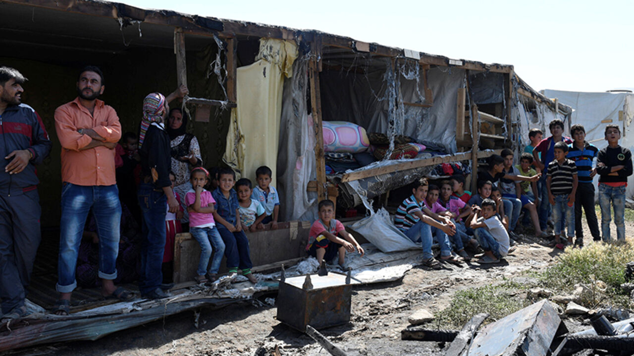 LEBANON-REFUGEES/FIRE Syrian Refugees are seen at a damaged site after a fire broke out inside their camp in Bar Elias town, in the Bekaa valley, Lebanon July 4, 2017. REUTERS/Hassan Abdallah - RTX39Y5W
