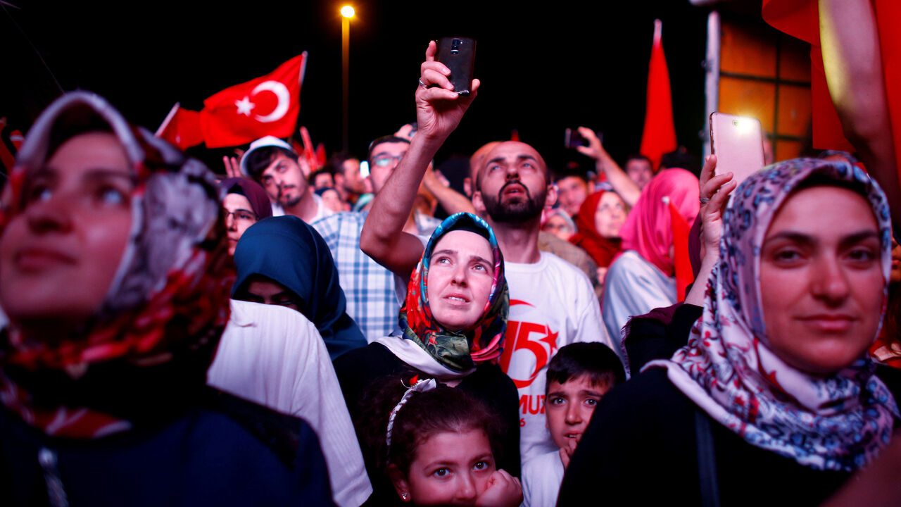TURKEY-SECURITY/ANNIVERSARY People listen to the speech of Turkey's President Tayyip Erdogan during a ceremony marking the first anniversary of the attempted coup at the Bosphorus Bridge in Istanbul, Turkey, July 15, 2017. REUTERS/Osman Orsal TPX IMAGES OF THE DAY - RTX3BLUL