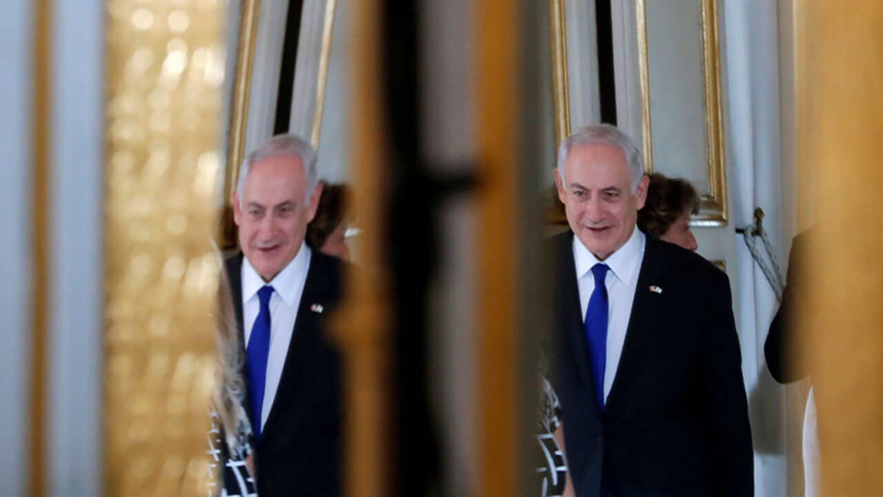 FRANCE-ISRAEL/ Israeli Prime Minister Benjamin Netanyahu is reflected in a mirror as he attends a joint declaration with French President Emmanuel Macron at the Elysee Palace in Paris, France, July 16, 2017. REUTERS/Stephane Mahe/Pool - RTX3BO2K