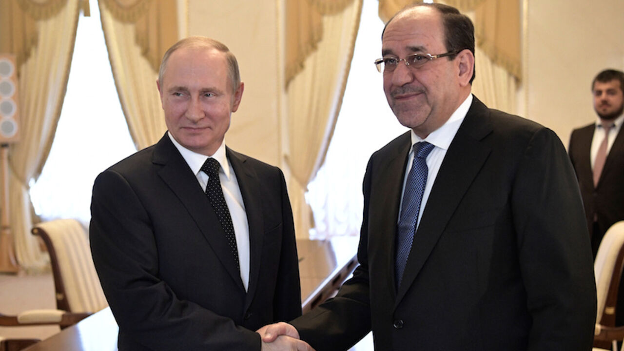 RUSSIA-IRAQ/ Russian President Vladimir Putin shakes hands with Iraqi Vice President Nuri al-Maliki during their meeting in St. Petersburg, Russia, July 25, 2017. Sputnik/Alexei Nikolsky/Kremlin via REUTERS ATTENTION EDITORS - THIS IMAGE WAS PROVIDED BY A THIRD PARTY. - RTX3CTS4