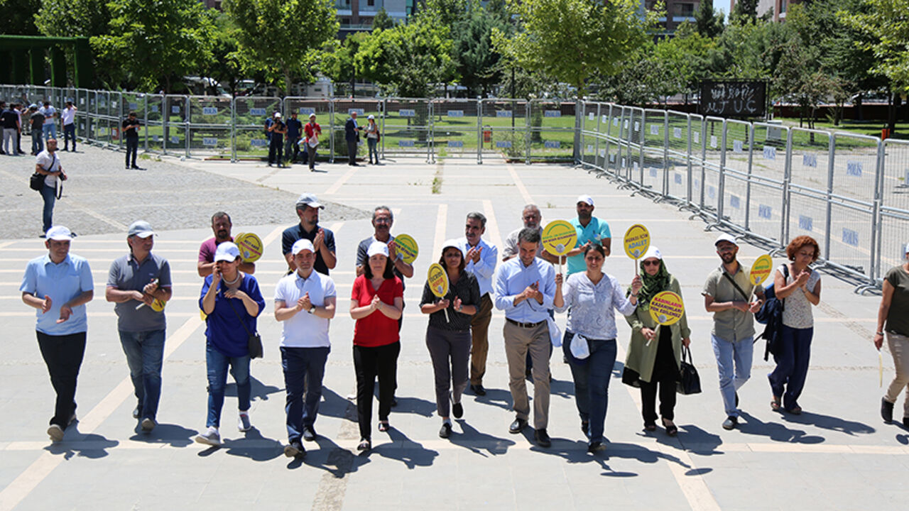 TURKEY-SECURITY/KURDS Pro-Kurdish opposition Peoples' Democratic Party (HDP) lawmakers walk with placards in Kurdish and Turkish during a protest against a state crackdown, which has seen dozens of lawmakers and mayors jailed over suspected links to militant separatists, in Diyarbakir, Turkey July 26, 2017. REUTERS/Sertac Kayar - RTX3CYDA