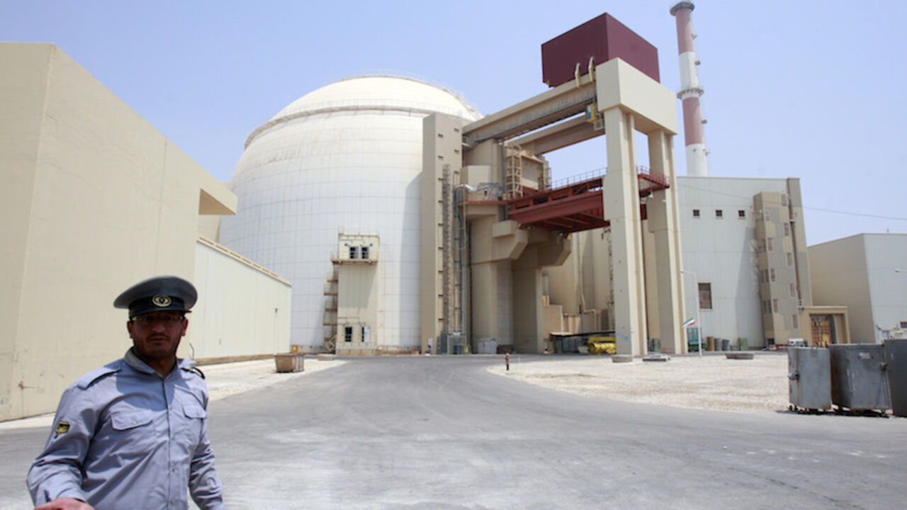 IRAN-NUCLEAR/BUSHEHR EDITORS' NOTE: Reuters and other foreign media are subject to Iranian restrictions on leaving the office to report, film or take pictures in Tehran.
A security official talks to journalists in front of Bushehr main nuclear reactor, 1,200 km (746 miles) south of Tehran, August 21, 2010. Iran began fuelling its first nuclear power plant on Saturday, a potent symbol of its growing regional sway and rejection of international sanctions designed to prevent it building a nuclear bomb. REUTERS/Raheb Homavandi