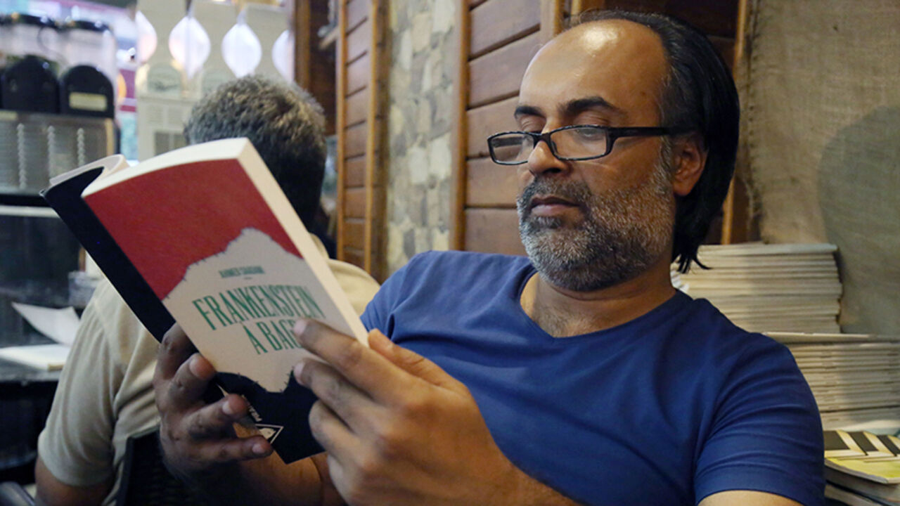 AFP_DT8W4 Iraqi writer, Ahmed Saadawi poses with his book titled in French "Frankenstein a Bagdad" (Frankenstein in Baghdad) on August 4, 2016 in the capital Baghdad.
When Ahmed Saadawi finished writing "Frankenstein in Baghdad", a dark fantasy about the war that tore Iraq apart a decade ago, he thought his novel dealt with the past. But just like the monster Mary Shelley first dreamt up exactly 200 years ago, Saadawi's hero took on a life of its own. Saadawi won the International Prize for Arabic Fiction in 2014 and